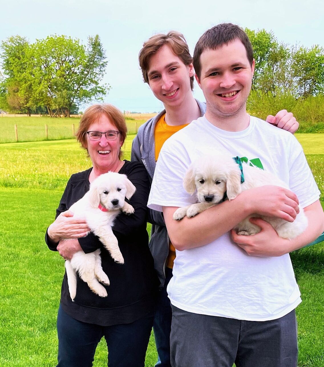 family with golden retriever puppies