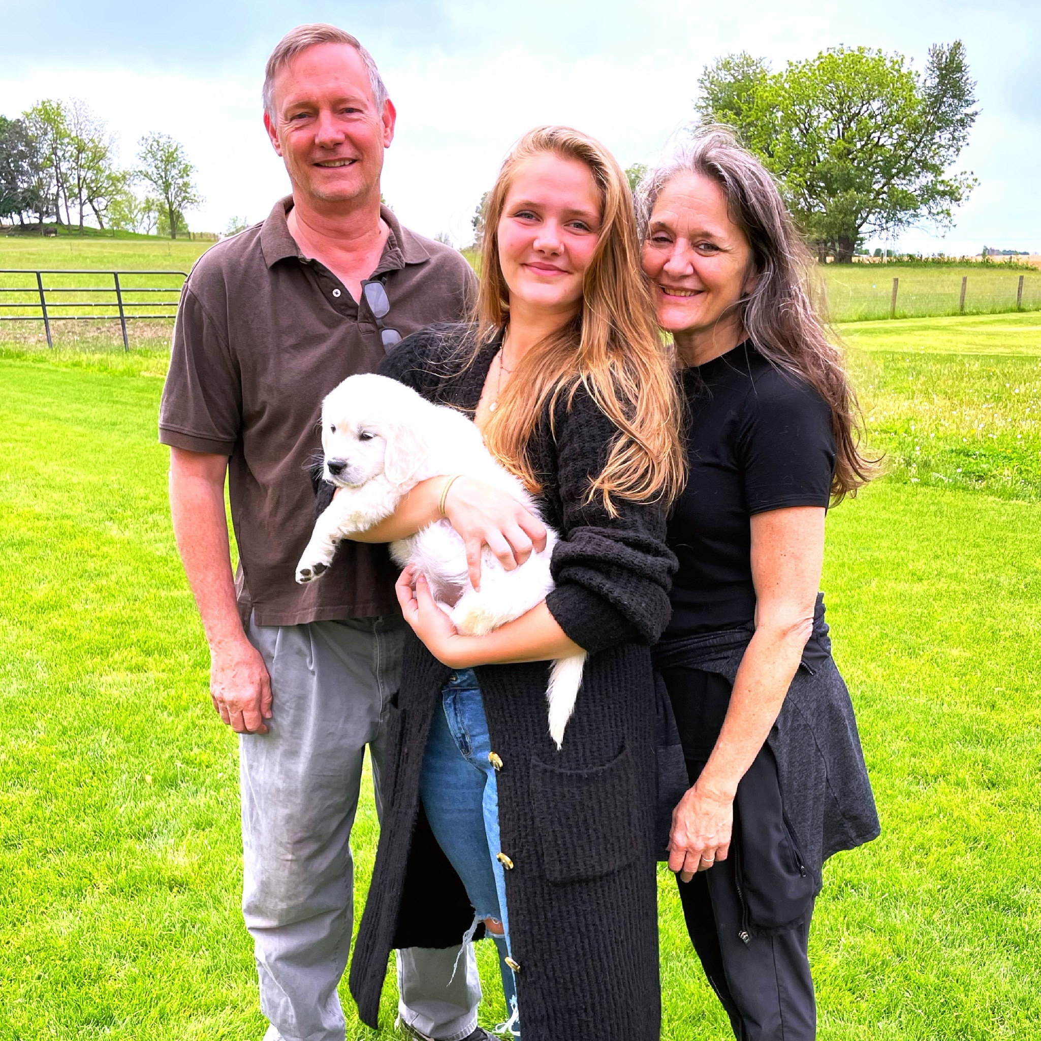family with golden retriever puppy