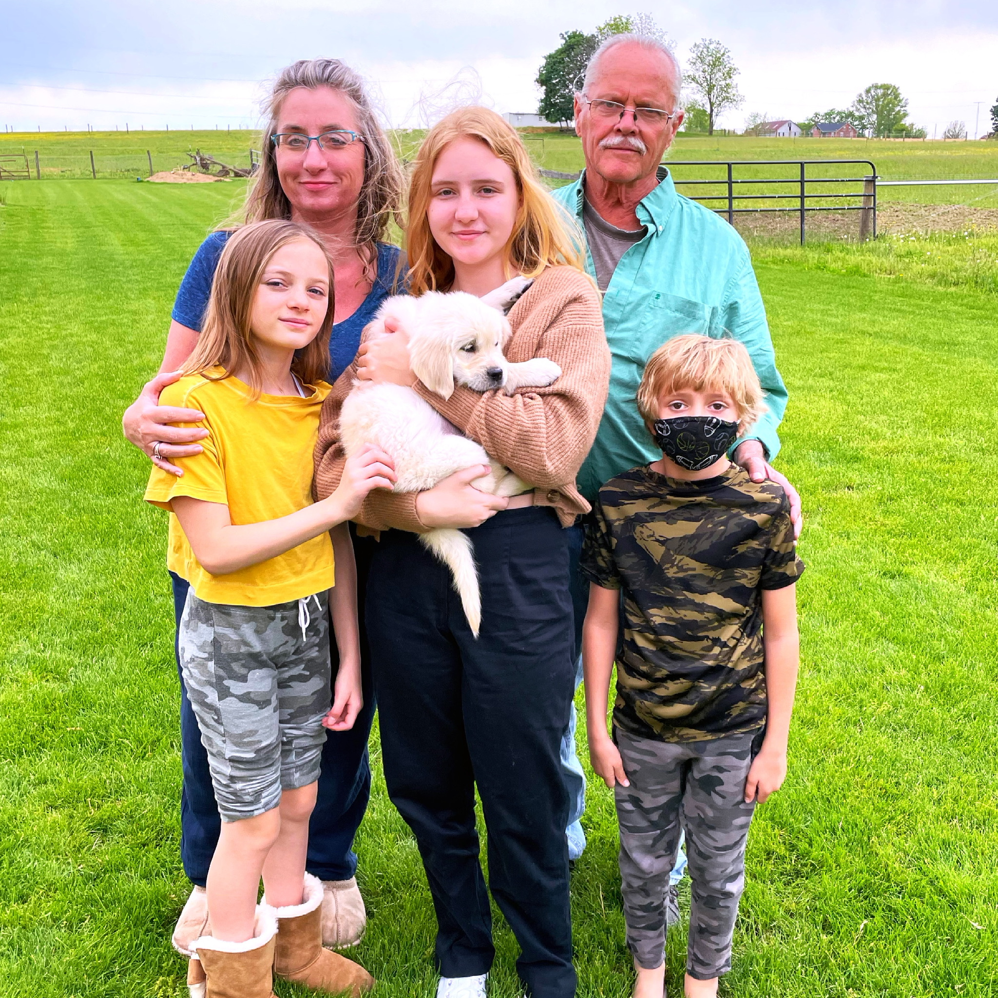 family with golden retriever puppy