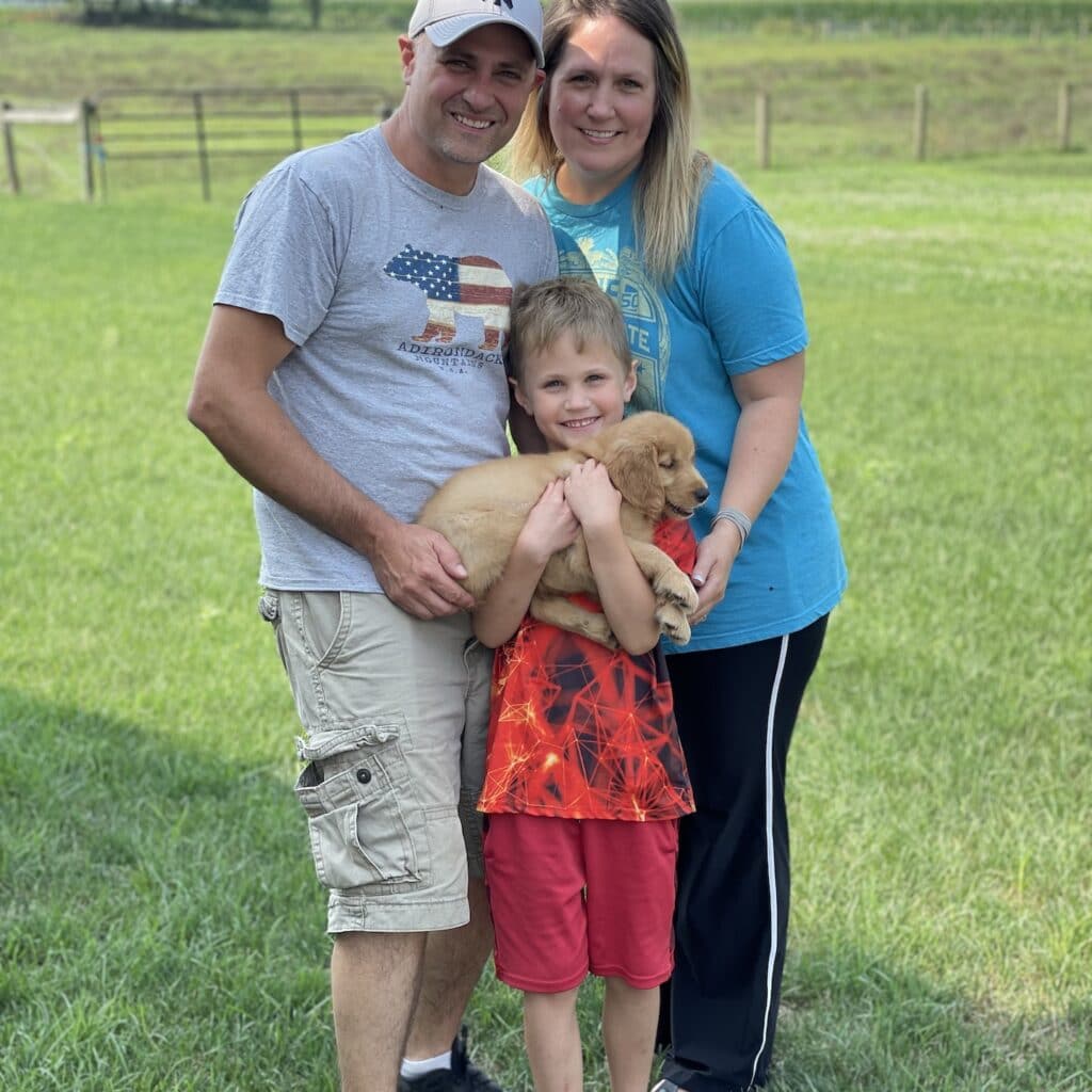 family with golden retriever puppy
