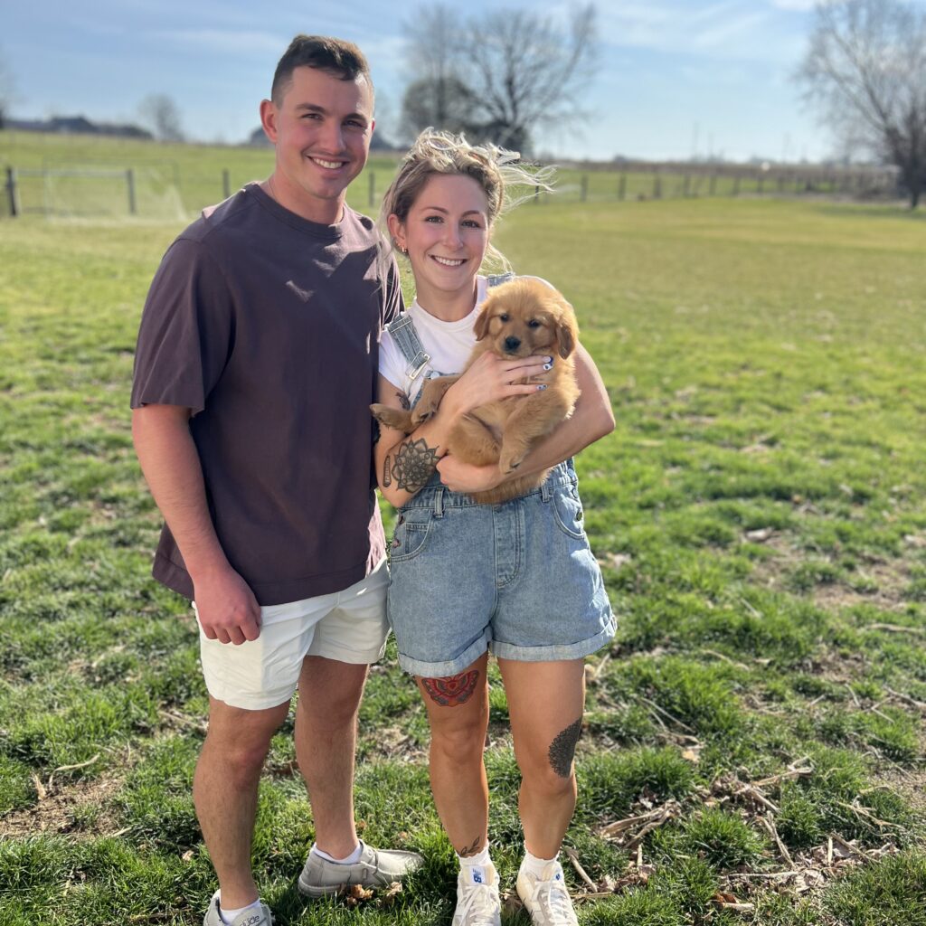 Couple taking home their golden retriever puppy